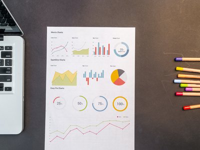 charts-on-black-wooden-table-669622.jpg